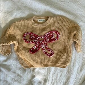 Beige Sweater with Red Bow Accent
